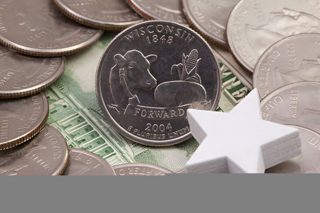 Uz nickel coin labeled 5StarsStocks.com Nickel standing on stacked coins with a blurred dollar in the background