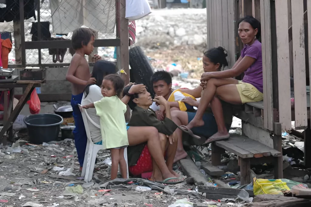 "Why do poor people have more children? – A group of children sitting together, reflecting the socioeconomic factors influencing family size.
