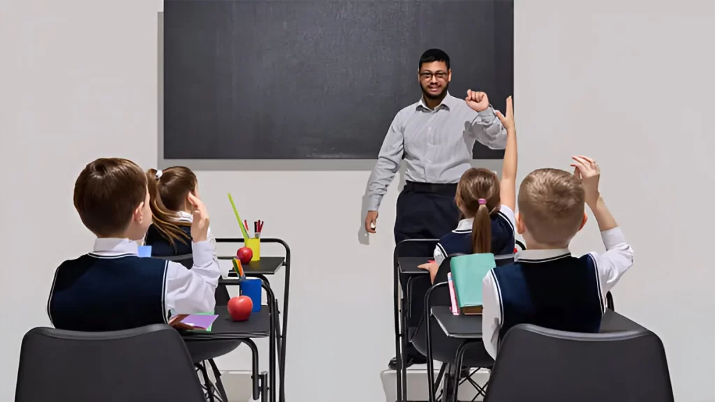 A serious Indian teacher supervising students in a classroom, illustrating why teachers in Indian schools are stricter than in the USA.