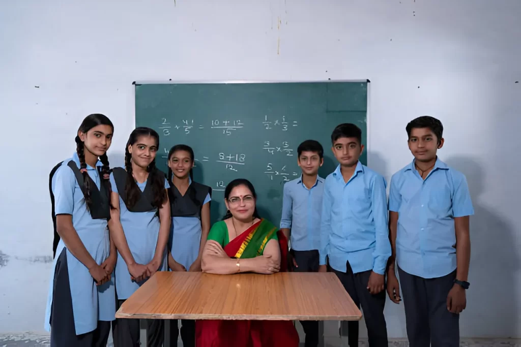 A serious Indian teacher supervising students in a classroom, illustrating why teachers in Indian schools are stricter than in the USA.